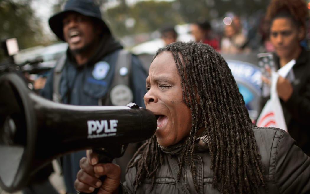 Activists celebrate outside the Leighton Criminal Courts Building after hearing the verdict in the murder trial of Chicago police officer Jason Van Dyke.