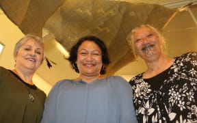 From left to right, Gloria Taituha, Jacqueline McRae-Tarei and Rose Te Ratana at a recent display of their work, standing under waka sails woven by Jacqueline.