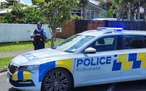 An armed police officer on Addington Ave in Manurewa, Auckland.