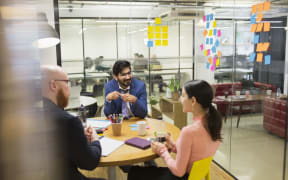 Creative business people brainstorming in conference room meeting.