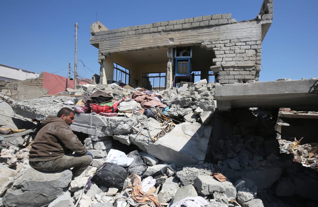 This file photo taken on March 26, 2017 shows an Iraqi man amid the rubble of destroyed houses in the Mosul al-Jadida area, following air strikes in which civilians have been reportedly killed during an ongoing offensive against the Islamic State (IS) group.
