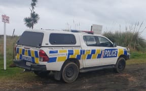 Police vehicle parked at Kiritehere Beach.