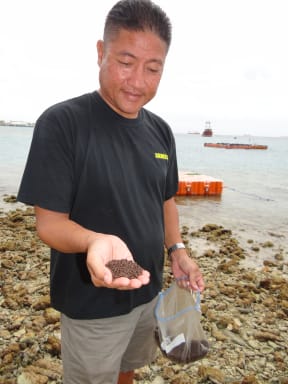 The mayor of Rongelap James Matayoshi with feed for the fish farming project