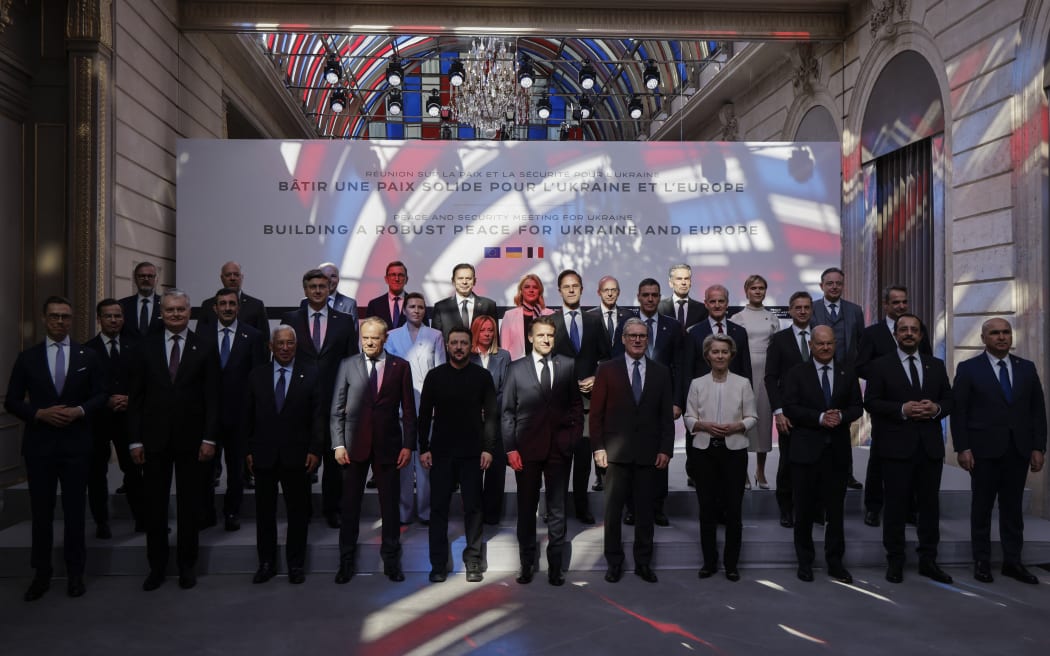 Officials pose for a family picture during a meeting as part of a summit for "coalition of the willing" at the Elysee Palace, in Paris, on March 27, 2025. French President Emmanuel Macron on March 27, 2025 is to host European leaders including President Volodymyr Zelensky for a summit aimed at boosting Ukrainian security ahead of any potential ceasefire with Russia. (Photo by Ludovic MARIN / POOL / AFP)