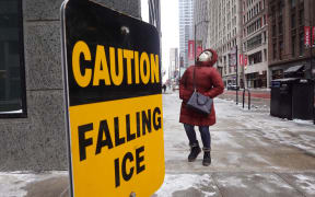 CHICAGO, ILLINOIS - DECEMBER 23: A pedestrian walks through downtown as temperatures hover in the negative single-digits on December 23, 2022 in Chicago, Illinois. Sub-zero temperatures are expected to grip the city for the next couple of days with wind chill temperature dipping as low as -40 degrees.   Scott Olson/Getty Images/AFP (Photo by SCOTT OLSON / GETTY IMAGES NORTH AMERICA / Getty Images via AFP)