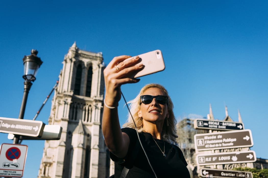 On the first weekend after the fire that devastated Notre-Dame de Paris Cathedral, tourists swarmed in front of the historic monument and took selfies.