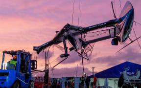 The damaged Black Foils SailGP Team F50 catamaran is craned out of the water on Race Day 1 of the ITM New Zealand Sail Grand Prix in Auckland, New Zealand.