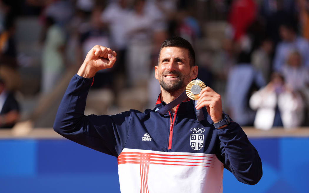 Novak Djokovic of Serbia celebrates winning the gold medal, Mens Singles final match at Roland Garros, Paris.
