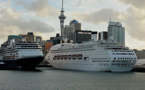 Cruise ships (C) lie tied up at Auckland's Viaduct Harbour during the 2011 Rugby World Cup on October 14, 2011. Auckland in New Zealand's North Island has the largest urban area in the country with just over one million people living there.  AFP PHOTO / Greg WOOD (Photo by GREG WOOD / AFP)