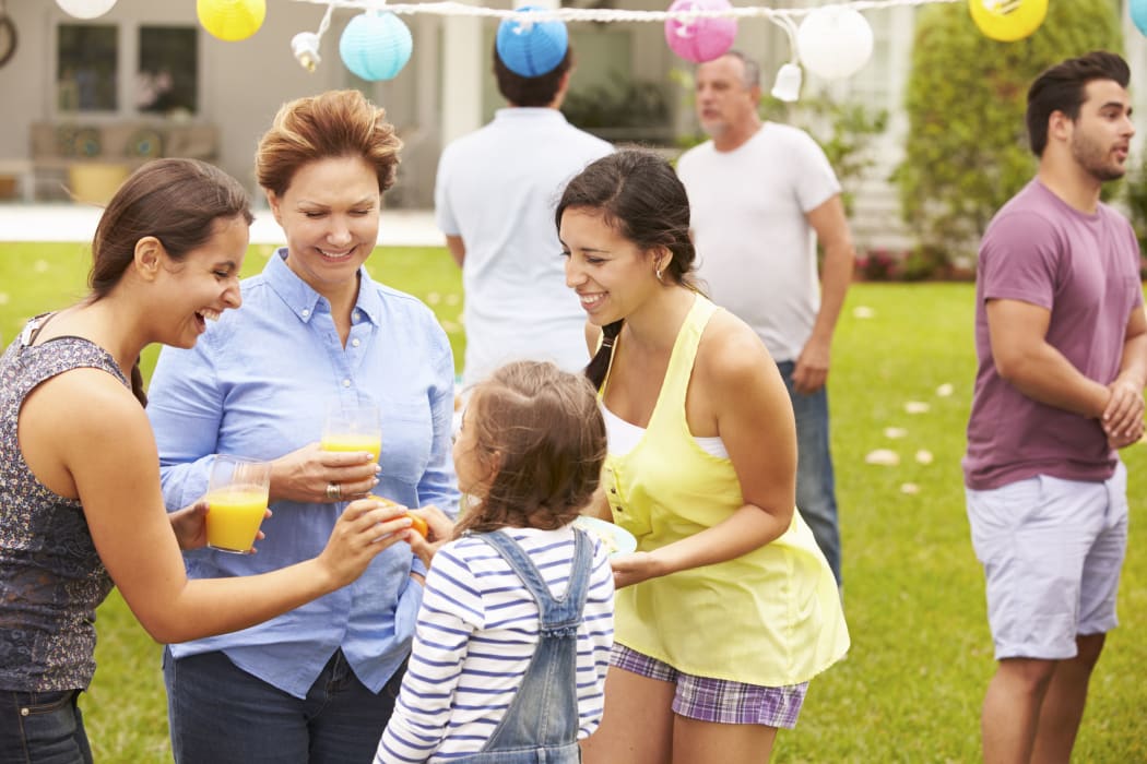 33550343 - multi generation family enjoying party in garden together