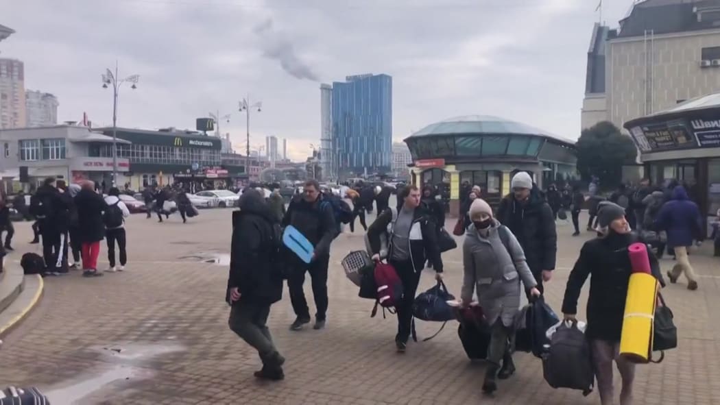 Residents rushing to take shelter as an air raid siren wails in Kyiv.