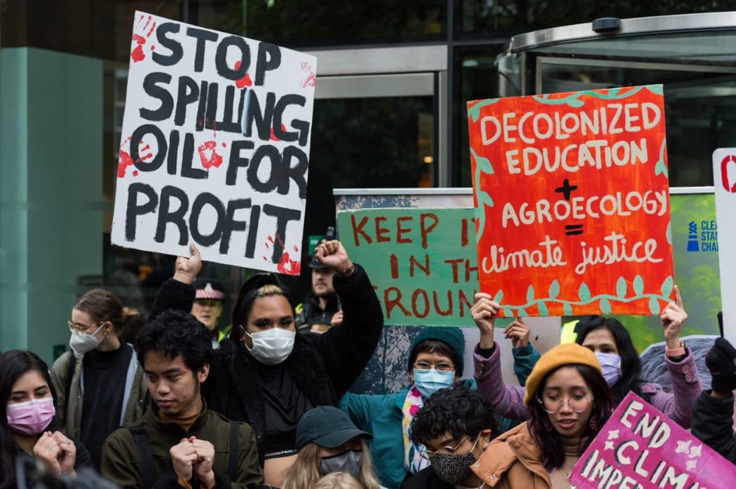 LONDON, UNITED KINGDOM - OCTOBER 29: Youth climate activists protest outside the Standard Chartered HQ against financing of fossil fuel projects during Defund Climate Chaos global day of action