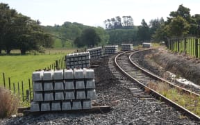 Railway sleepers are stacked by the thousands across the Far North for an upgrade that's now on hold.