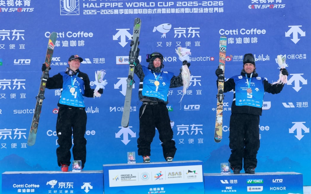 Men’s freeski halfpipe champion Finley Melville Ives is flanked by runner-up Luke Harrold, left, and bronze medallist Hunter Ives after the World Cup event in Secret Garden, China, 13 December, 2025. Credit Li Runsheng / FIS Park & Pipe