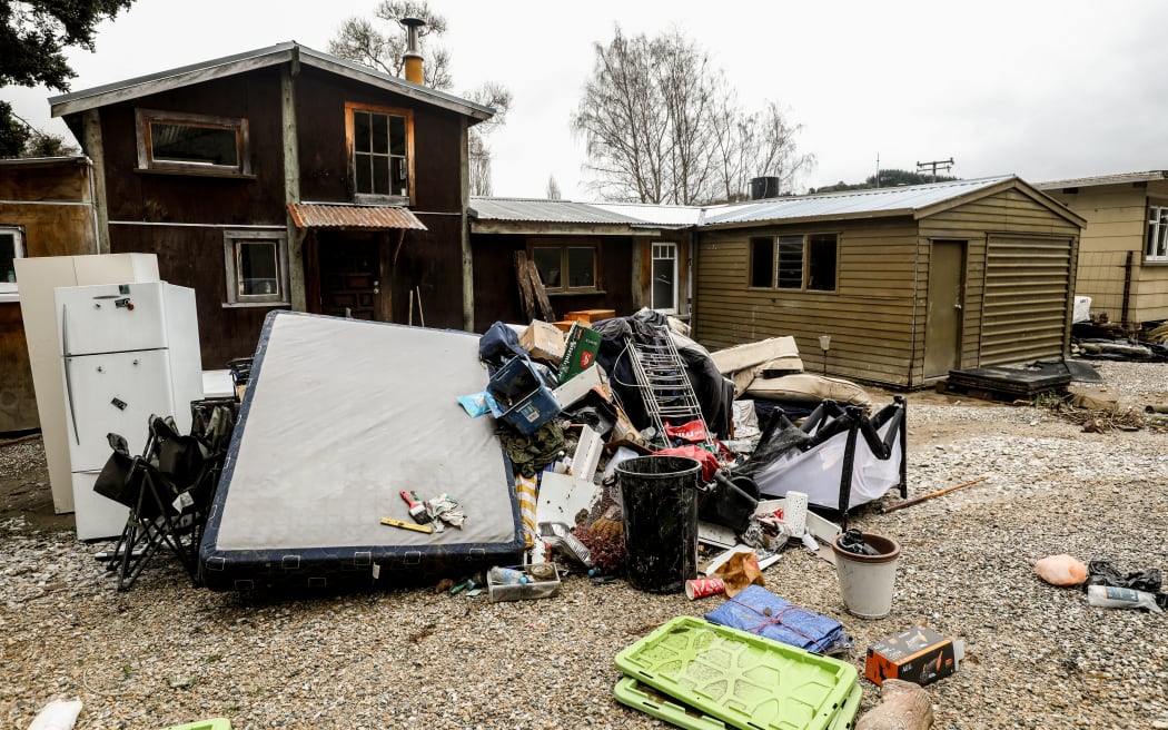 Flood damaged items piled up outside a property in the Motueka Valley.