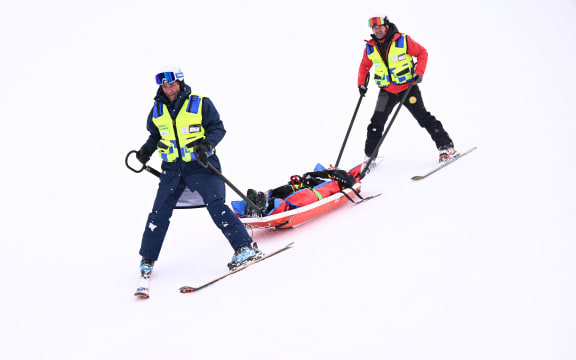 New Zealand's Finley Melville Ives is evacuated by a medical team in the freestyle skiing men's freeski halfpipe qualification run 2 during the Milano Cortina 2026 Winter Olympic Games at Livigno Snow Park, in Livigno (Valtellina), on February 20, 2026.