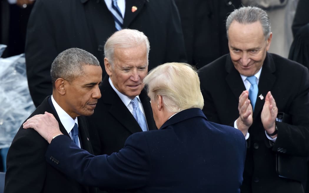US President Donald Trump(C)speaks with former President Barack Obama as former Vice President Joe Biden and New York Sen. Chuck Schumer look on during his inauguration ceremonies at the US Capitol in Washington, DC.