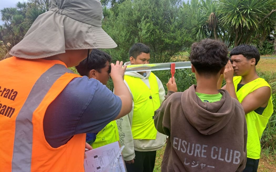 Māngere College students inspect water quality of nearby Te Ararata stream.