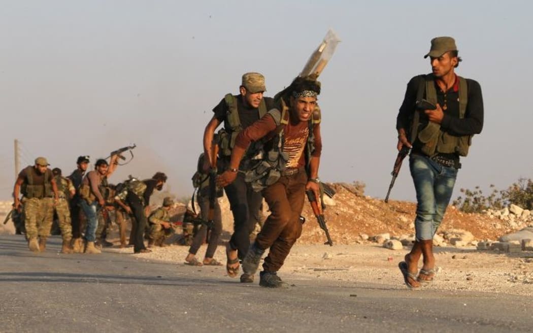 Fighters from the Free Syrian Army take part in a battle against the Islamic State (IS) group jihadists in the northern Syrian village of Yahmoul in the Marj Dabiq area north of the embattled city of Aleppo on October 10, 2016.