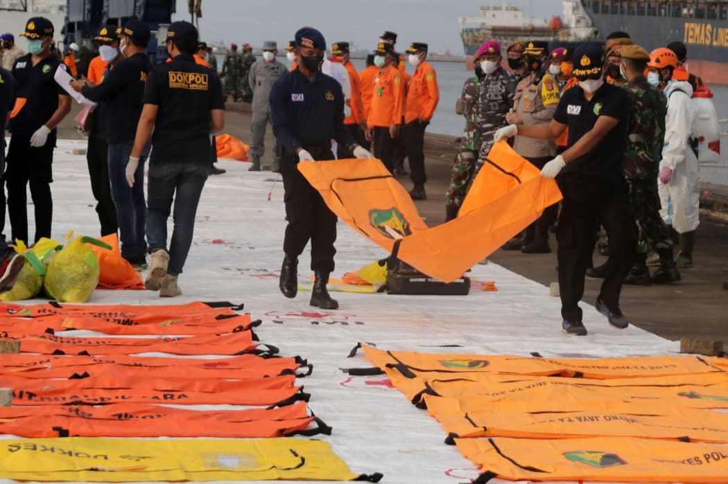 JAKARTA, INDONESIA - JANUARY 11: Navy members and rescue (SAR) officers bring body parts of victims and debris of Sriwijaya Air SJ 182, found 23 meters deep in the sea, for inspection at the crisis center at Tanjung Priok Port, Jakarta.