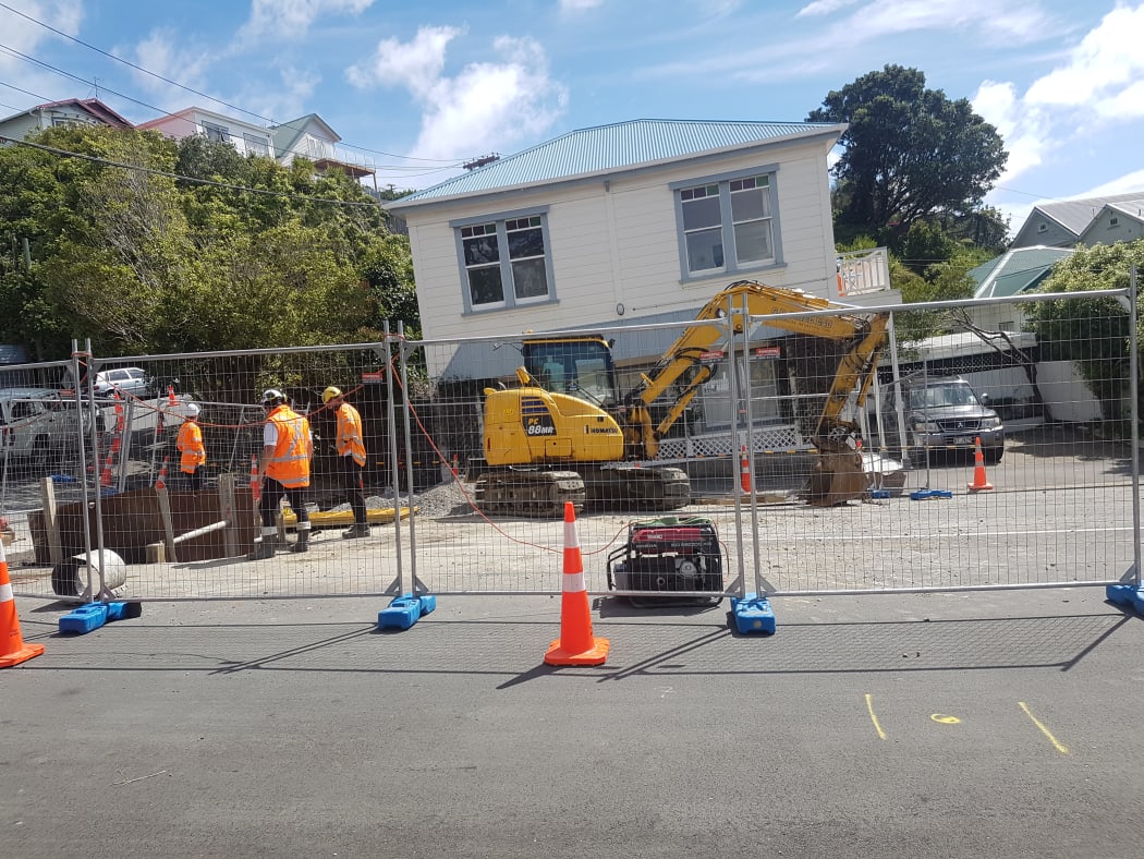 Workers at the site of the main break in Helen Street in the Wellington suburb of Brooklyn.
