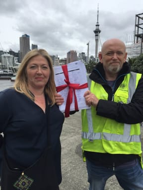 Delegates from Rail and Maritime Union hold stack of more than 5000 signatures.