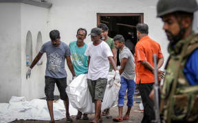 Dead Bodies are carried away for identification in front of the St Anthony's Church.