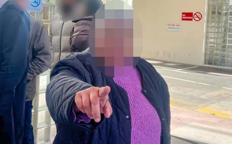 A woman reportedly shoved a NZ Herald reporter in the face outside court in Wellington where a prominent sportsman was appearing.