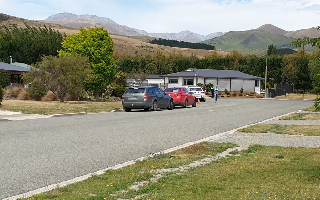 A patrol car and other vehicles at the scene of the police shooting in Kurow.