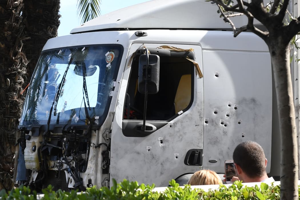 The truck that was used in the attack is towed away.