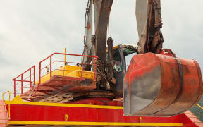 Big colorful excavator of sea tanker, closeup view.