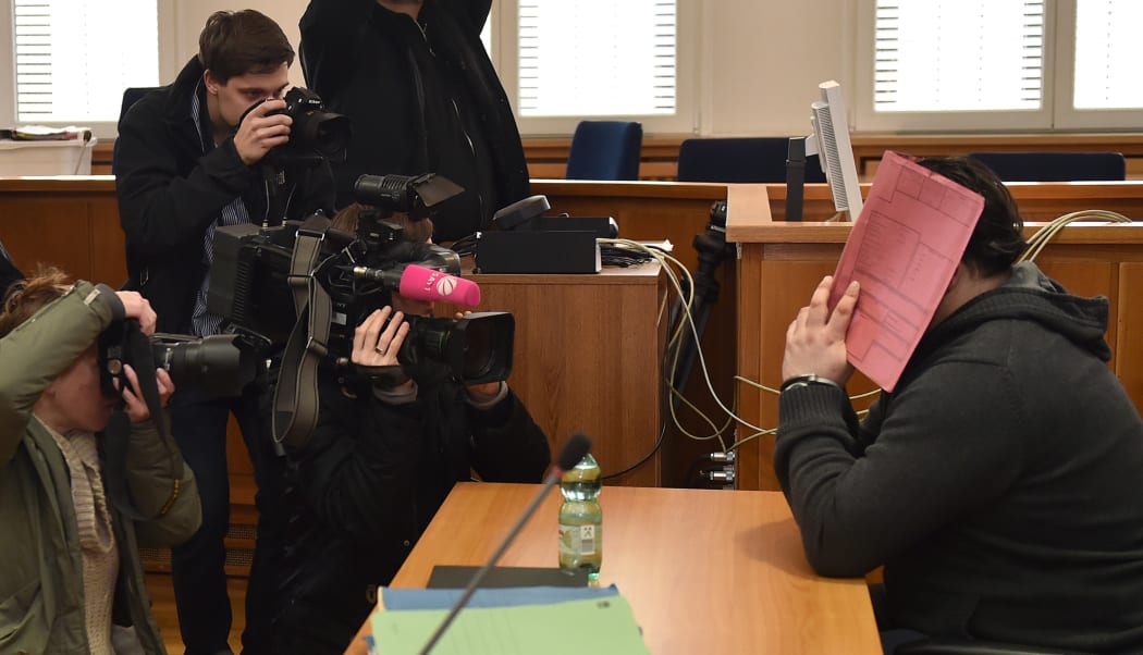 Niels H hid behind a folder during his trial last year.
