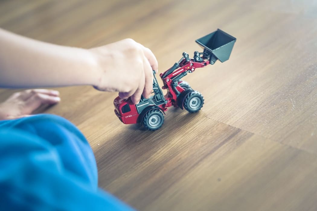 Child's hand with toy truck