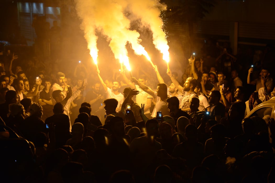 Supporters of the pro-Kurdish Peoples' Democratic Party celebrate the results of the Turkish presidential and parliamentary elections.