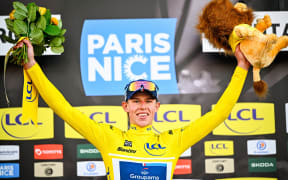 New Zealand's Laurence Pithie of Groupama-FDJ celebrates in the yellow jersey of leader in the overall ranking after the second stage of the Paris-Nice race, 2024.