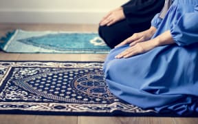 Muslim prayers in Tashahhud posture