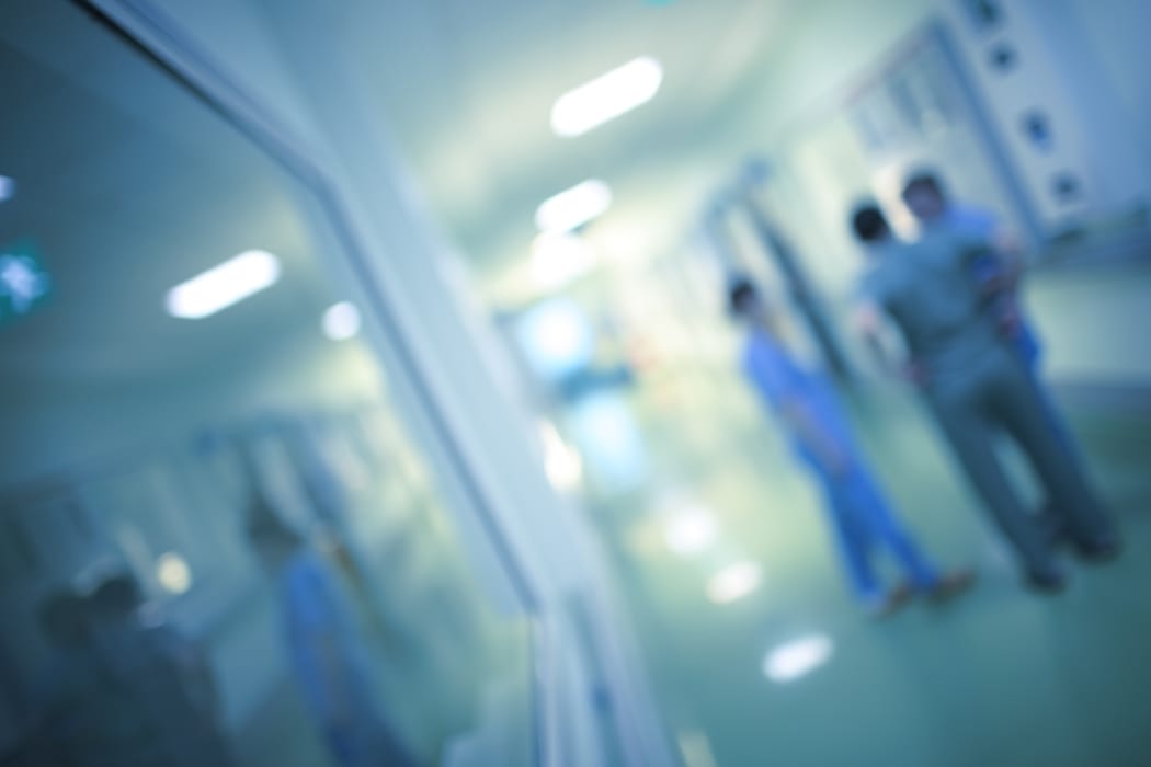 Health care workers in the hospital corridor.