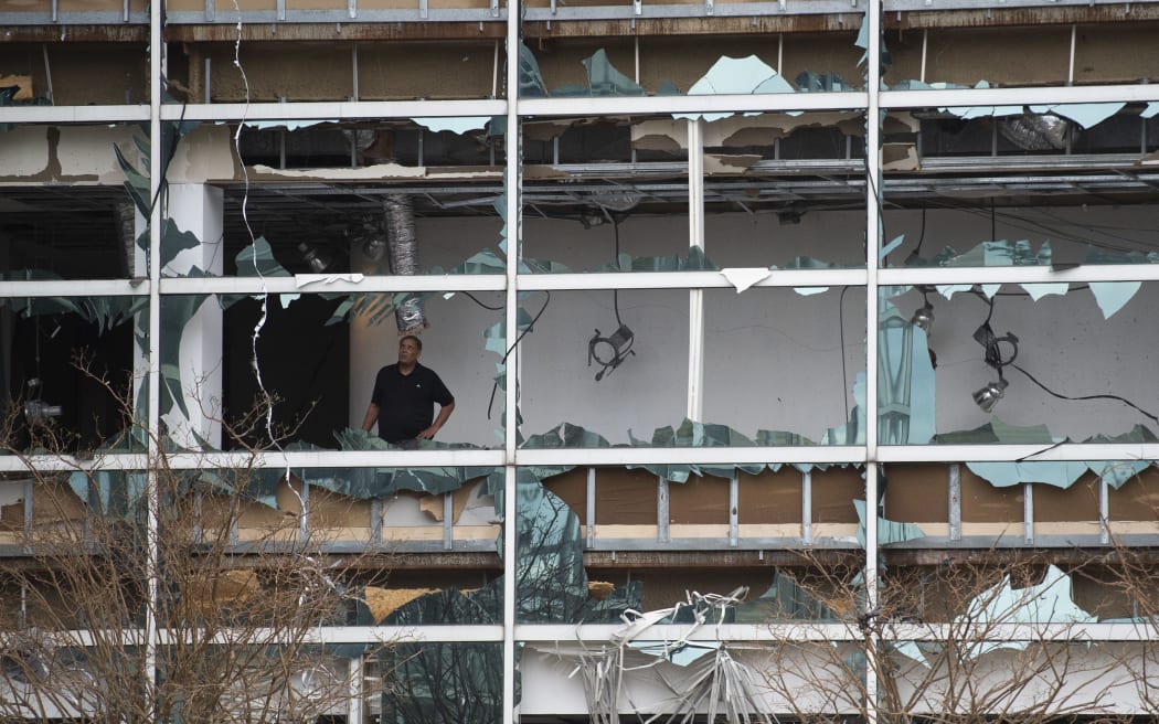 A man looks at damage inside the Capitol One Bank Tower, with its windows blown out in the downtown area after Hurricane Laura passed through on August 27, 2020 in Lake Charles, Louisiana.