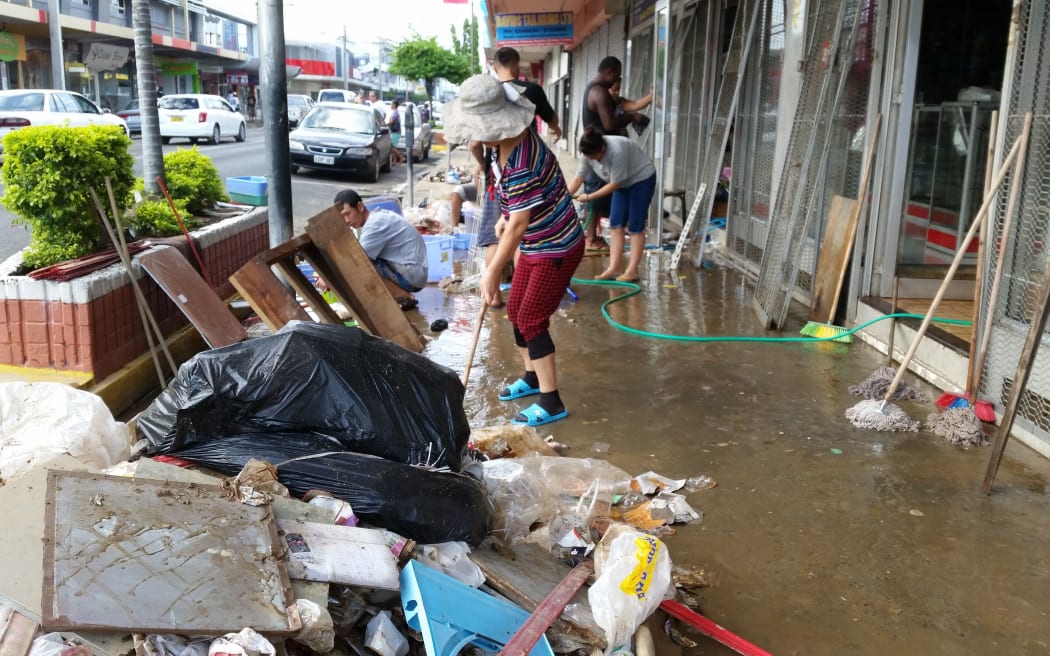 Nadi shopkeepers clean up outside their shops after flooding this week