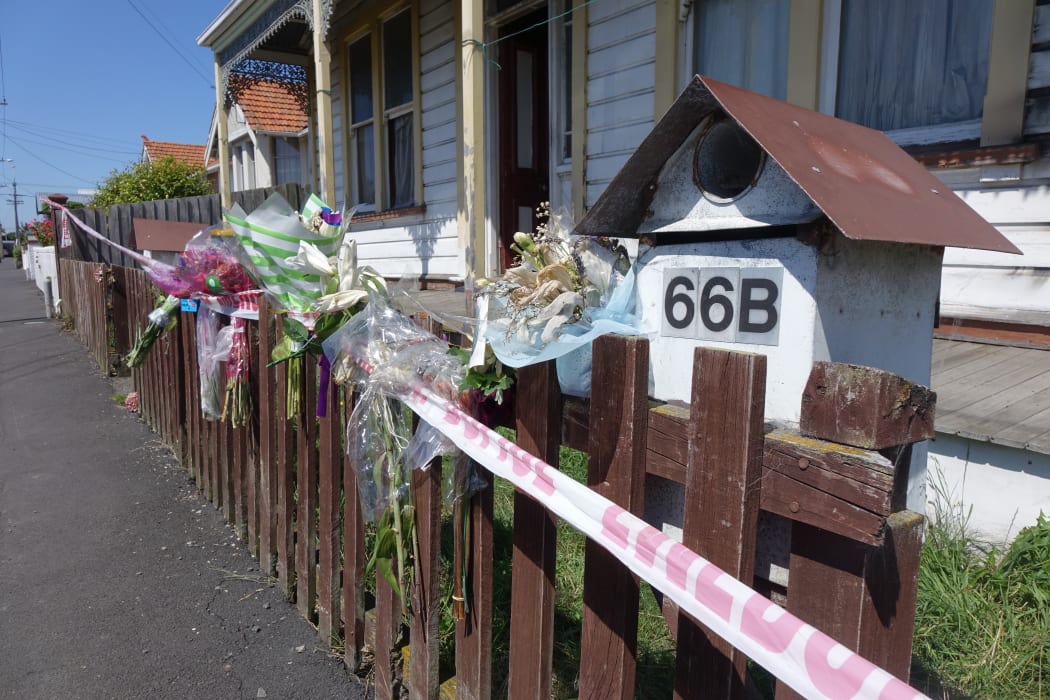 Bouquets line the fence of the Wesley property where the bodies of Anastasia Neve and David Clarke were found following their murders last week.