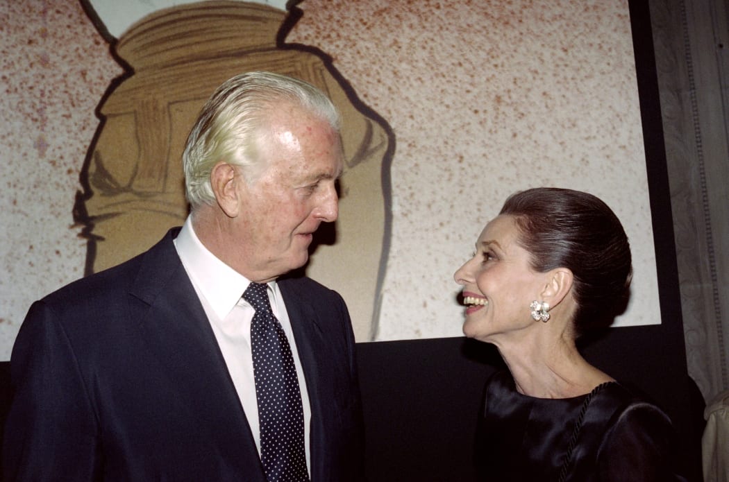 French designer Hubert de Givenchy and Audrey Hepburn talk together at the Galliera Museum in Paris during a reception honoring Givenchy for his 40 years in fashion.