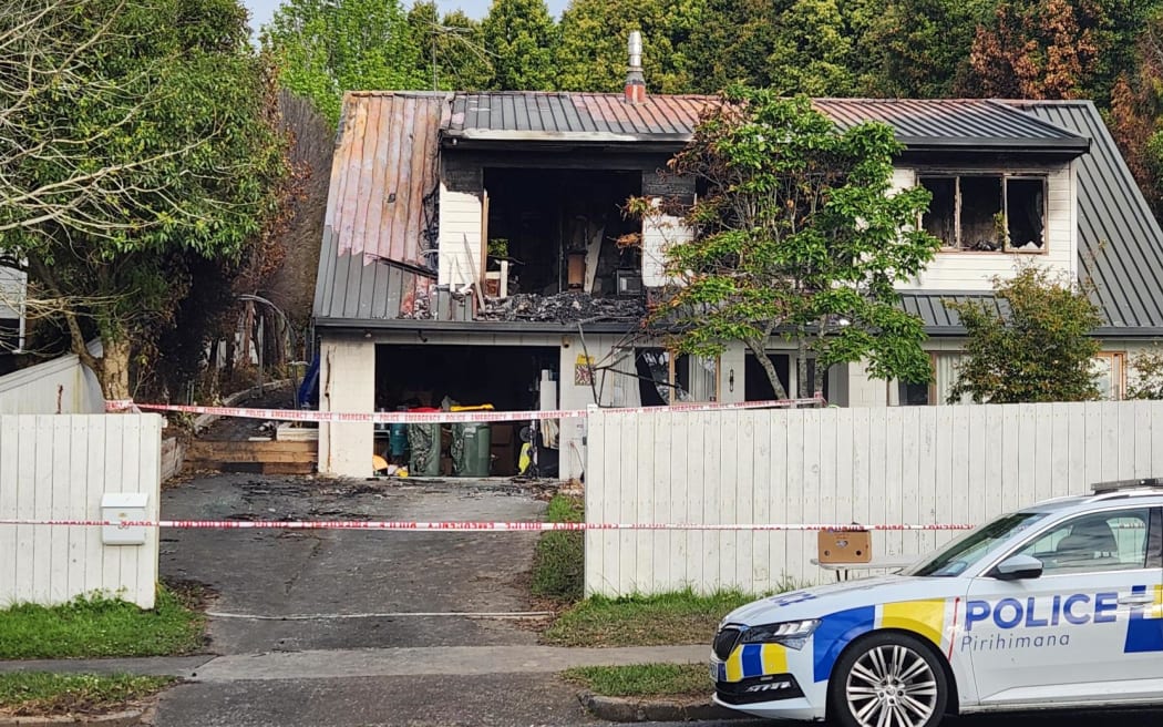 Police guard at the scene of the Bucklands beach double homicide fire.