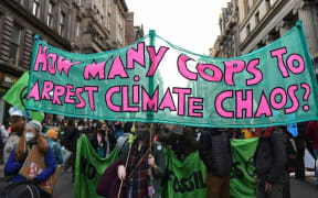 Young climate protesters march through the streets of Glasgow on Friday Nov 5, 2021 to demand action on climate change from leaders and politicians at COP26.