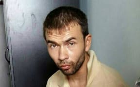 The Royal Thai police released this image of a Turkish national being held at a police station in Bangkok.