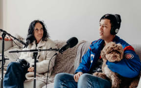 Moana Maniapoto sits next to her son Hikurangi Jackson, who is holding his dog, Rocky.