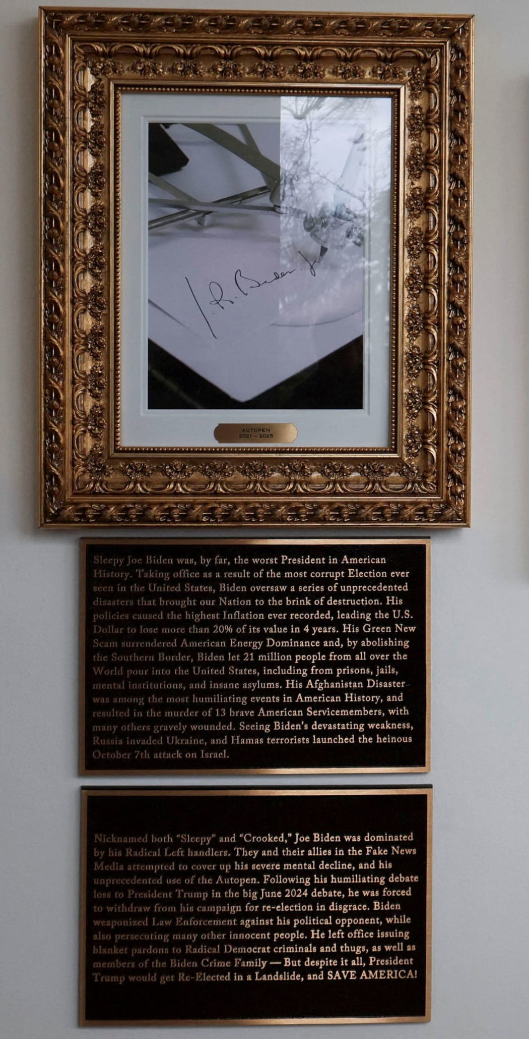 The plaque below an image of an autopen signing former President Joe Biden's signature, displayed in place of a portrait.
Mandatory Credit:	Jessica Koscielniak/Reuters via CNN Newsource