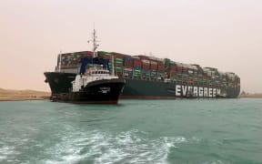 An image released by the Suez Canal Authority on 24 March 2021 shows 400m long container ship lodged sideways and impeding traffic across Egypt's Suez Canal.