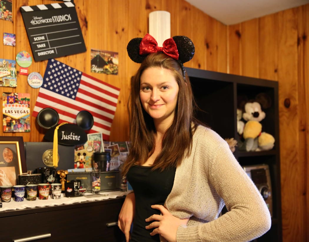 A portrait of Justine Conway wearing Disney paraphernalia