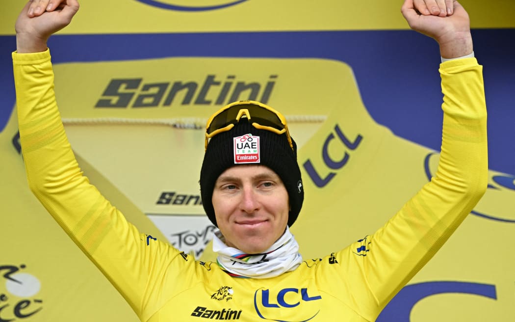 Slovenian rider Tadej Pogacar celebrates on the podium, 2025 Tour de France.