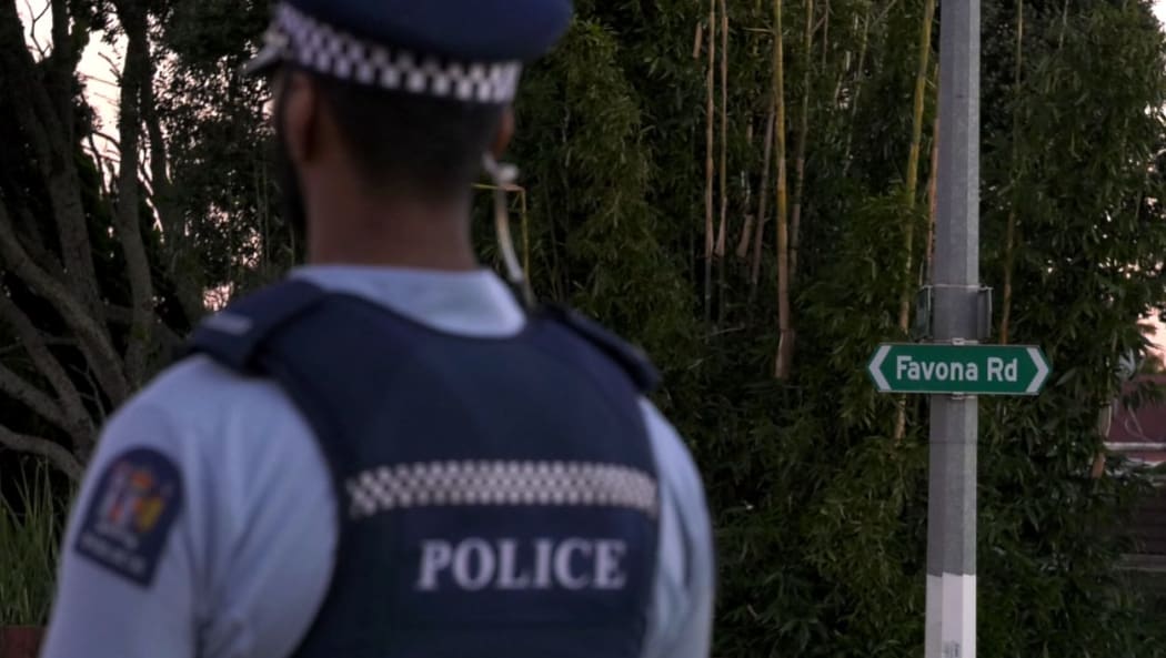 A police officer stands outside the house on Favona Road where the two-year-old was found dead on 2 June 2016.